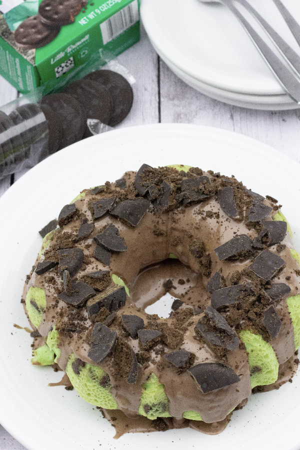 mint chocolate cake on a white plate next to a box of Girl Scout Thin Mint Cookies