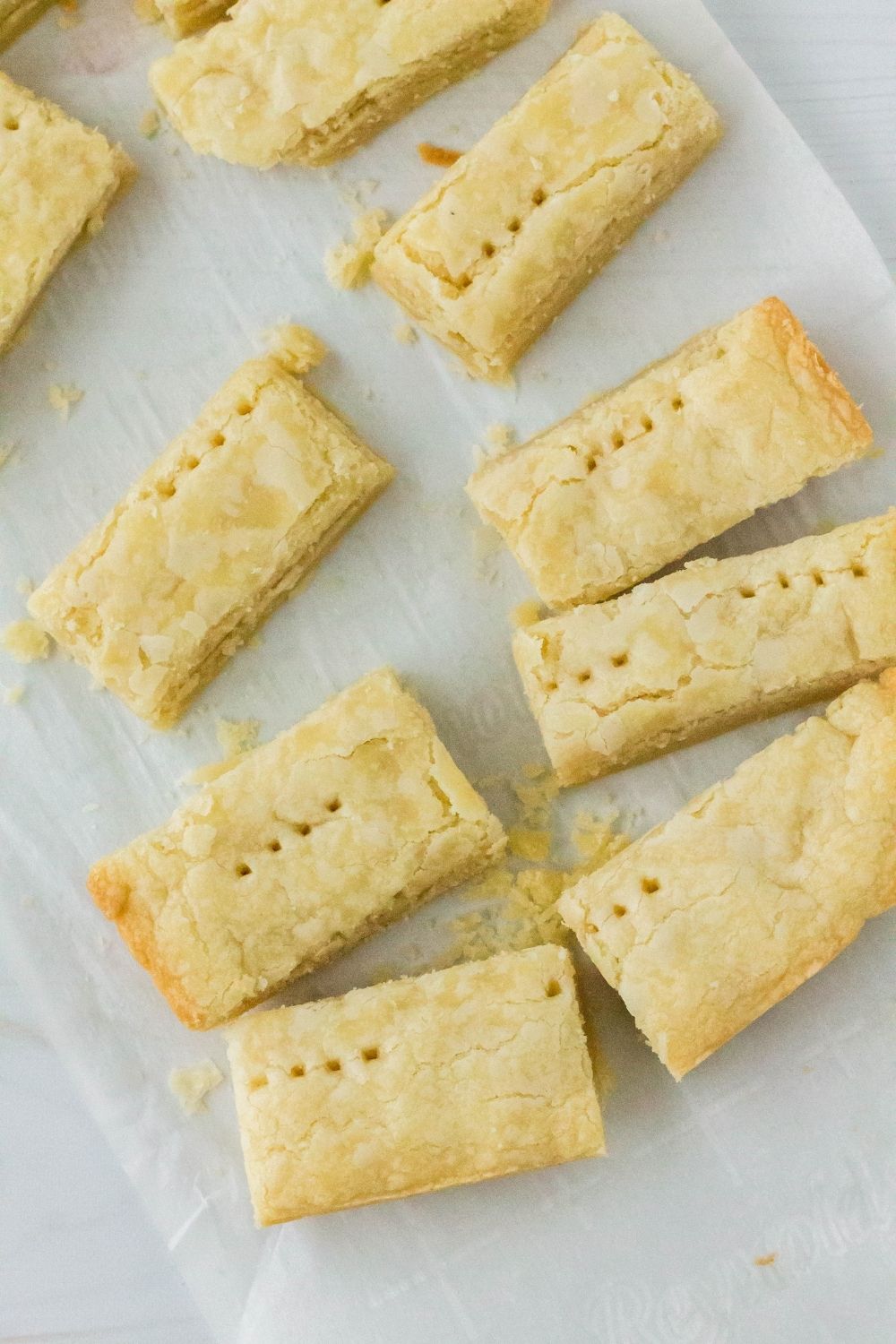 copycat Walker's Scottish shortbread cookies, freshly baked and sliced into fingers, on a piece of parchment paper