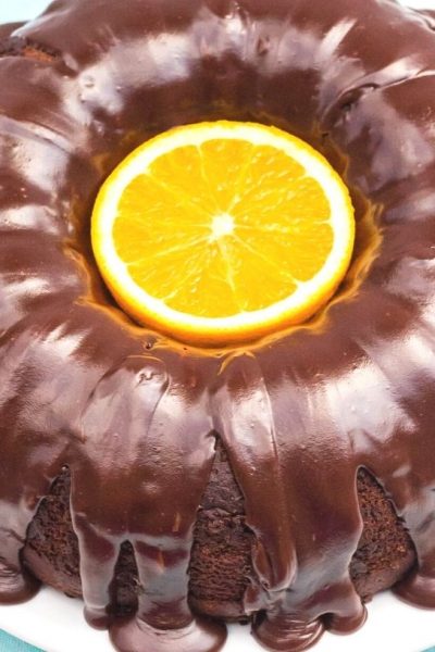 overhead view of a chocolate orange bundt cake with a sliced orange in the center