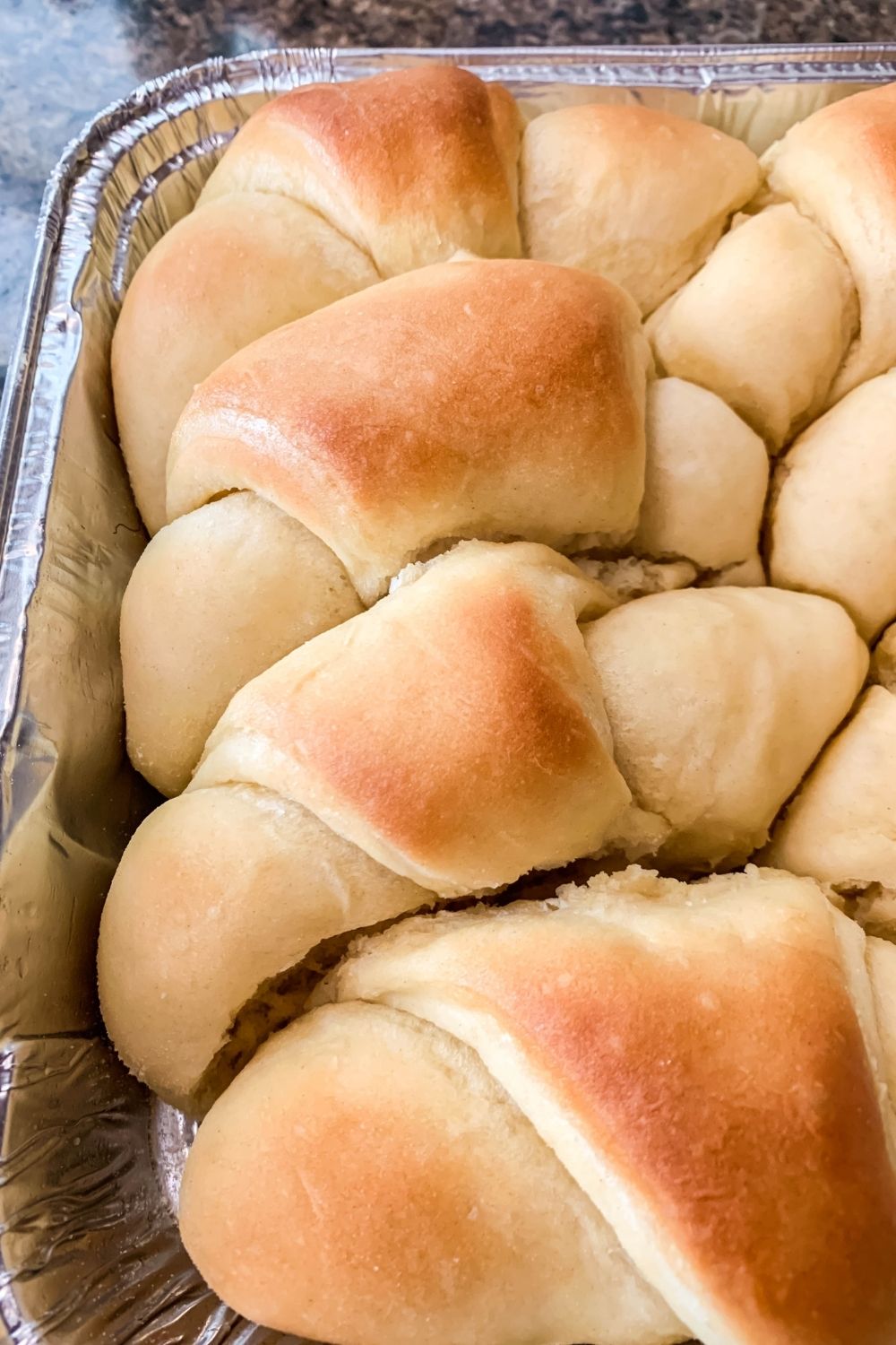 view of a foil pan with freshly baked crescent rolls proofed in the Instant Pot