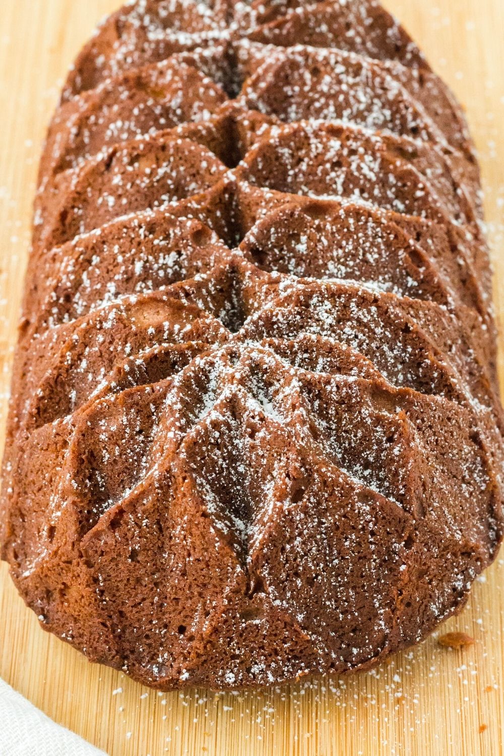 close-up view of an eggnog pound cake baked in a fluted loaf pan and sprinkled with powdered sugar
