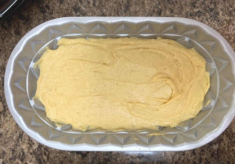 eggnog pound cake batter in a fluted loaf pan prior to baking