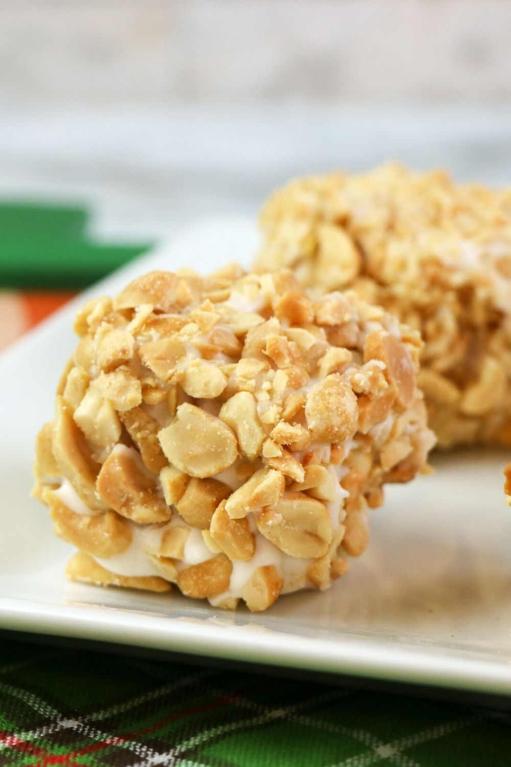 close-up view of blarney stone cake bars coated in peanuts and frosting