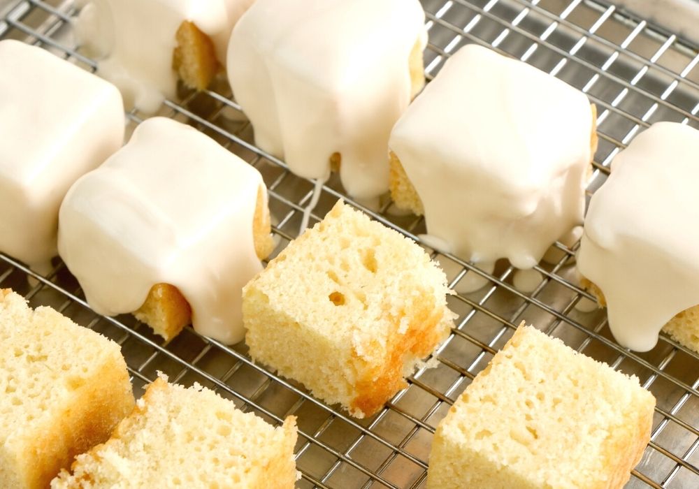cake squares with frosting drizzled over