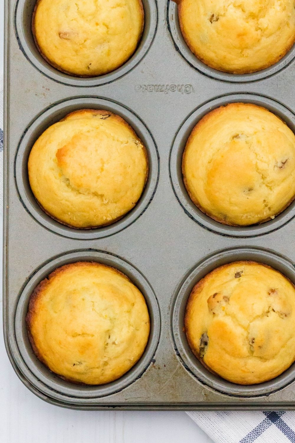 overhead view of a muffin tin with freshly baked German muffins in it