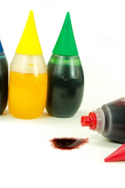 bottles of blue, yellow, green, and red food coloring