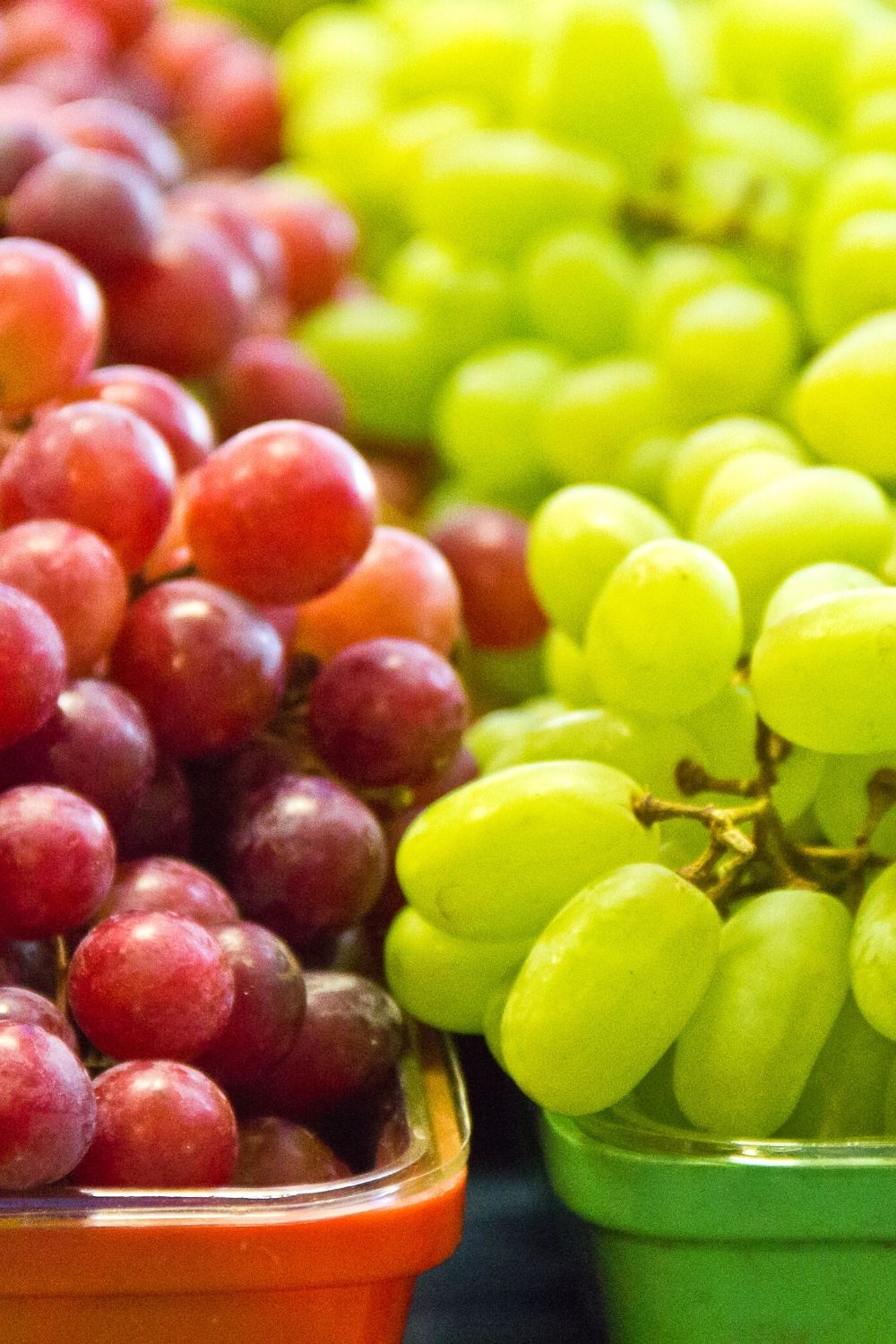 red and green grapes in matching containers