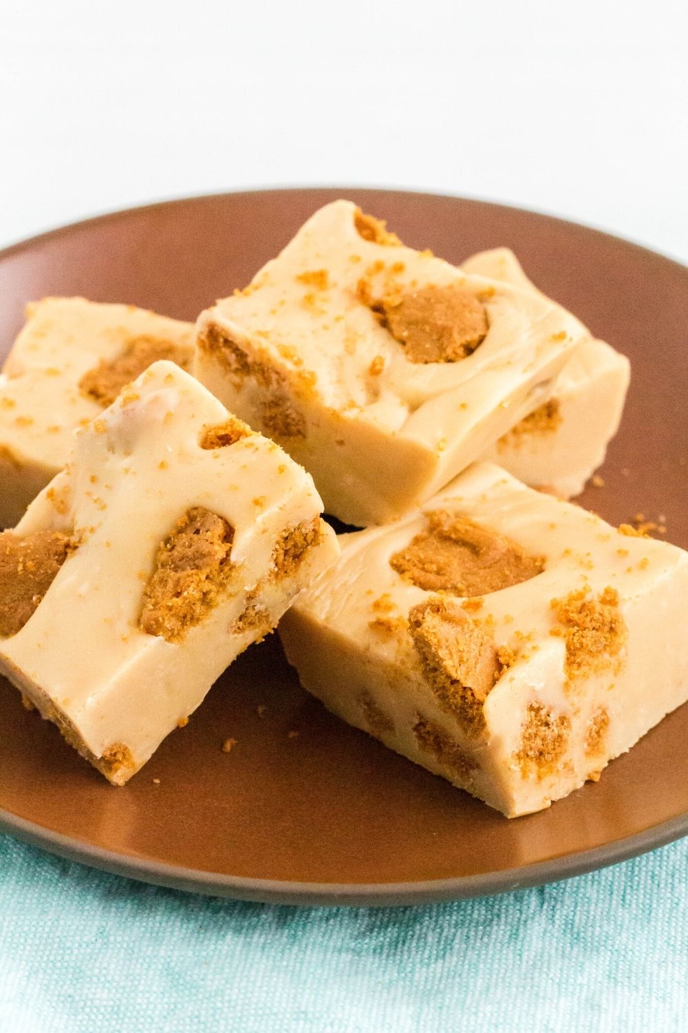 five pieces of easy Biscoff fudge served on a brown plate