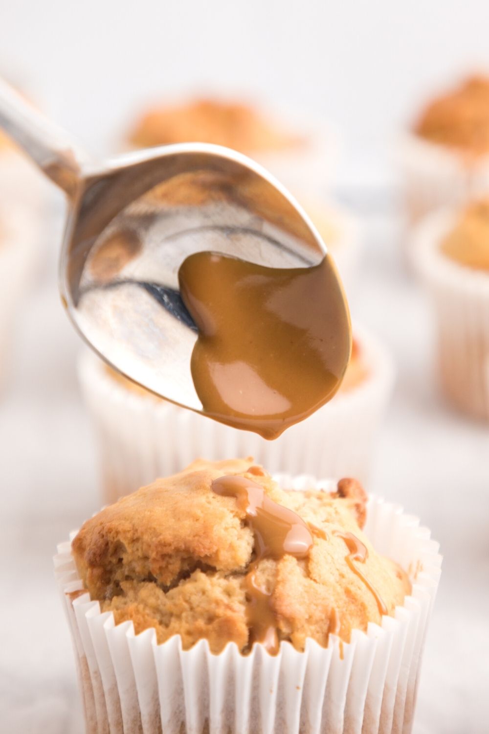 melted Lotus Biscoff cookie butter being drizzled over a muffin