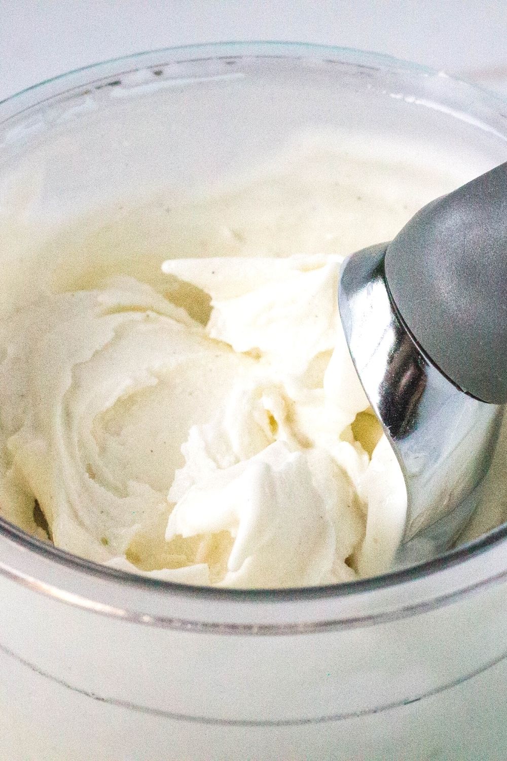 an ice cream scoop in a pint of ninja creami frozen yogurt