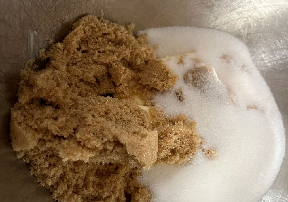 butter, sugar, and brown sugar combined in a mixing bowl