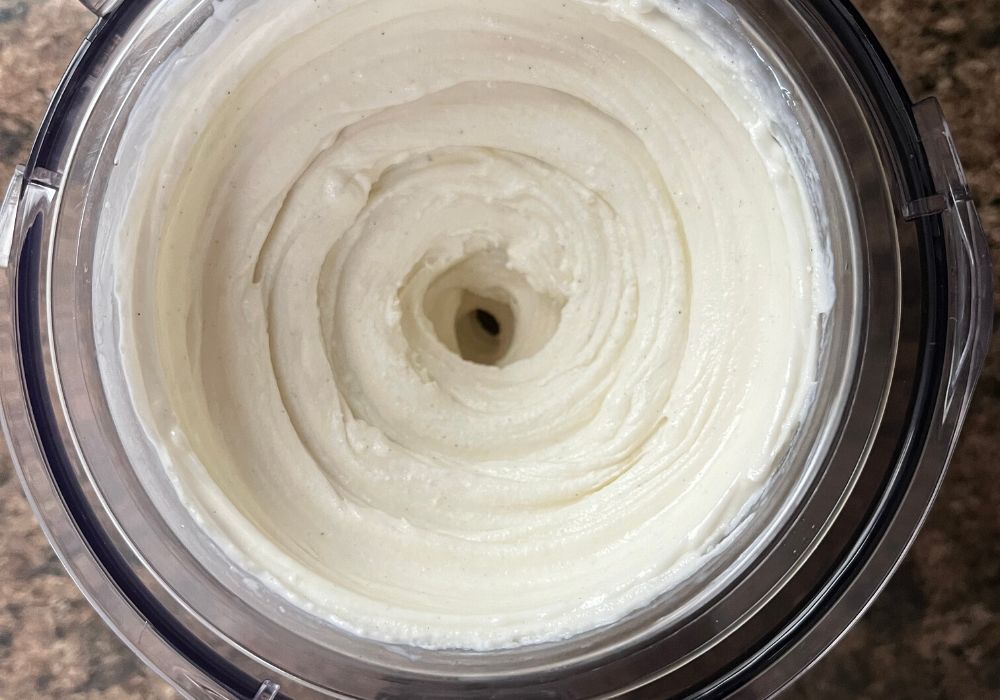 overhead view of a pint of ninja creami frozen vanilla yogurt