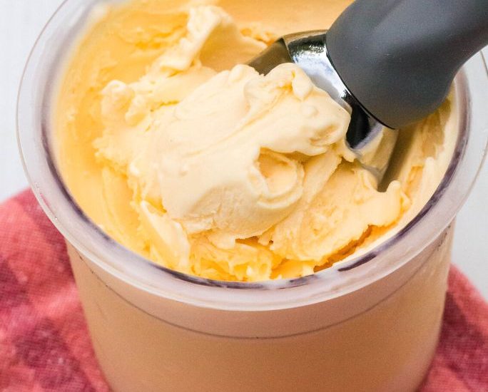 ninja creami eggnog ice cream in a pint with an ice cream scoop