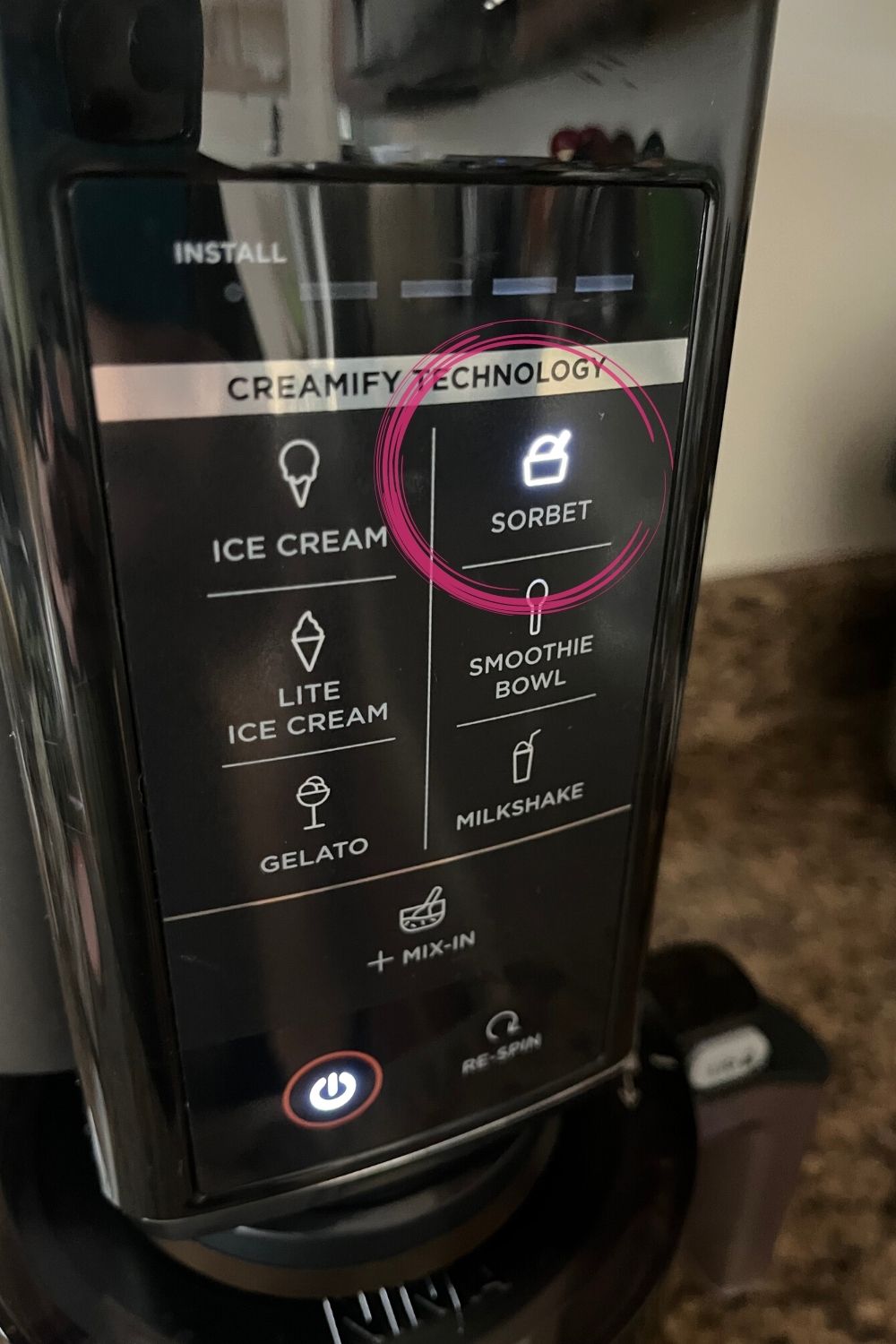 control panel of the ninja creami ice cream maker, with the sorbet button circled