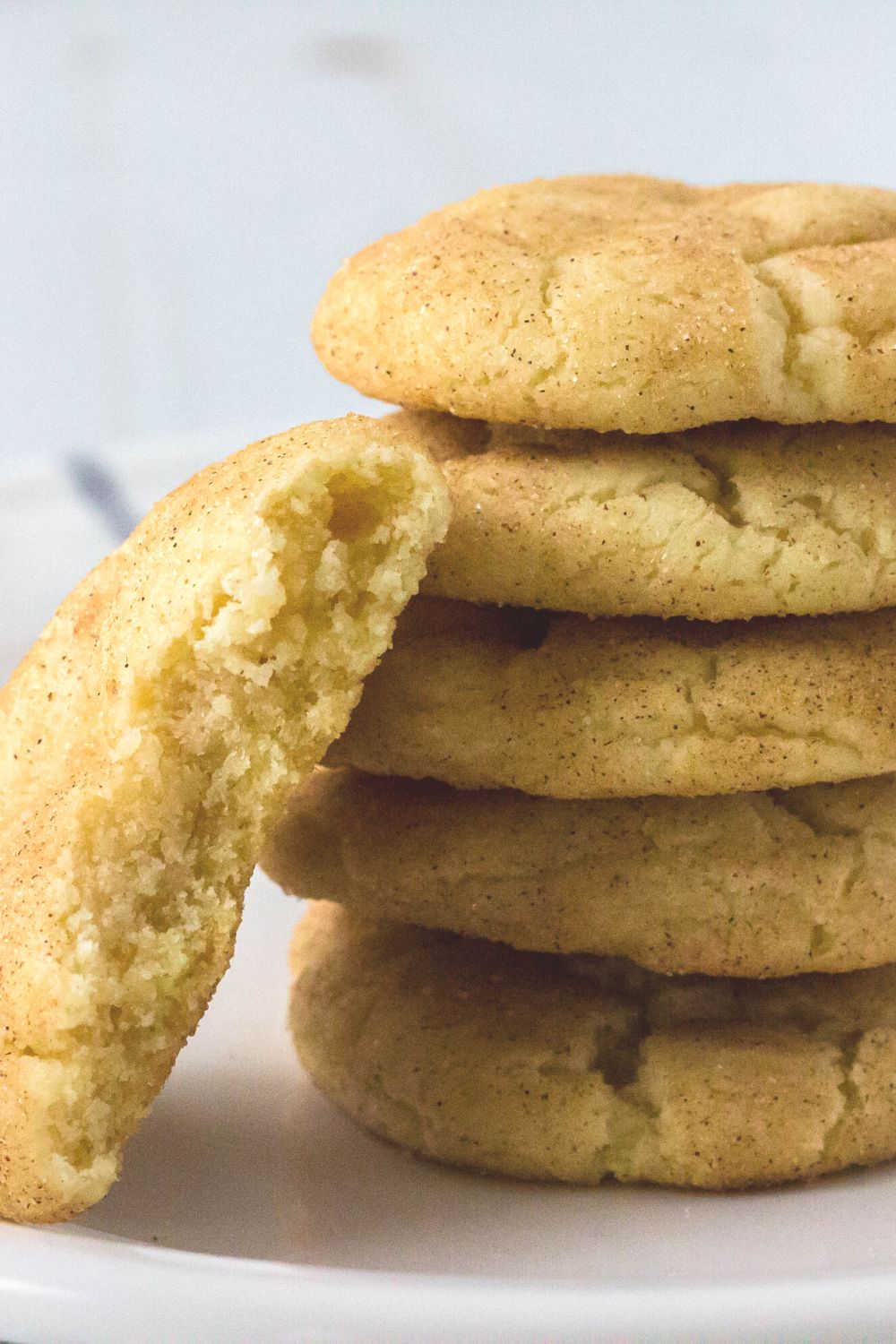 close-up view of a stack of easy snickerdoodles made without cream of tartar, with one cookie bitten in half