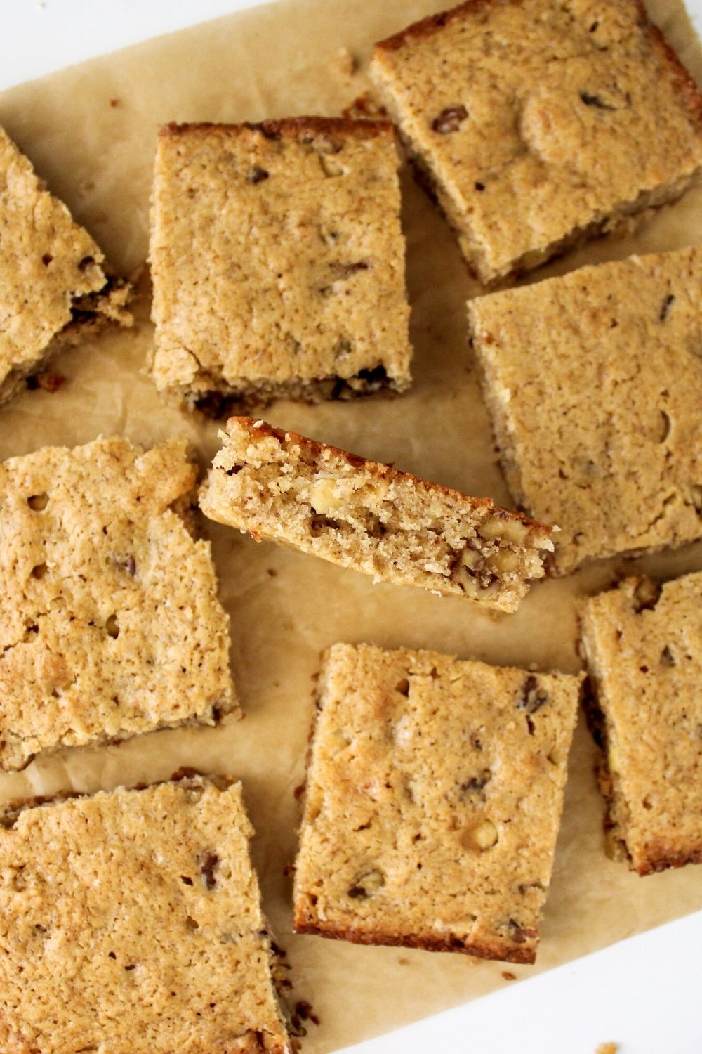 several eggnog blondie squares on a sheet of parchment paper