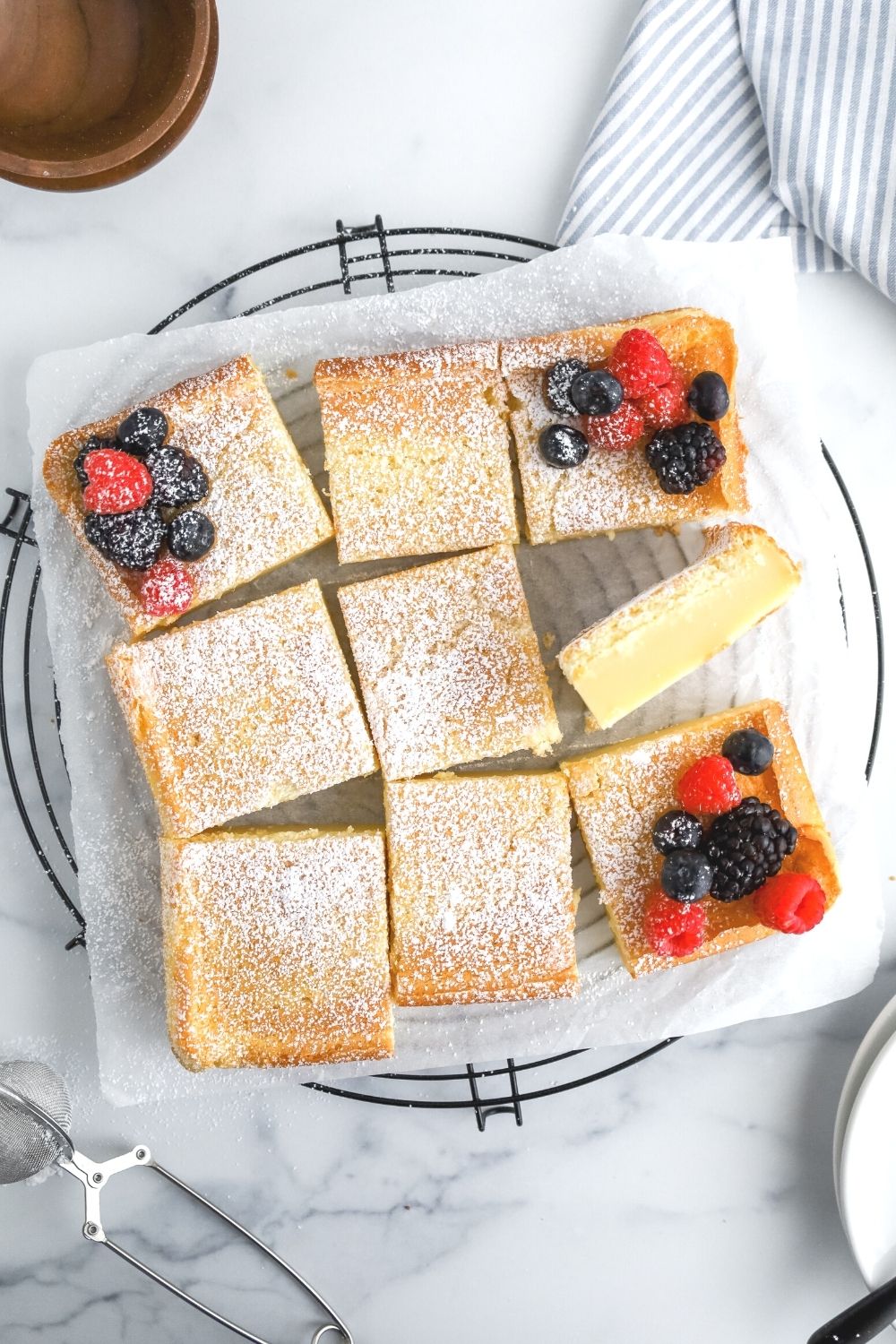 sliced squares of magic custard cake, dusted with powdered sugar