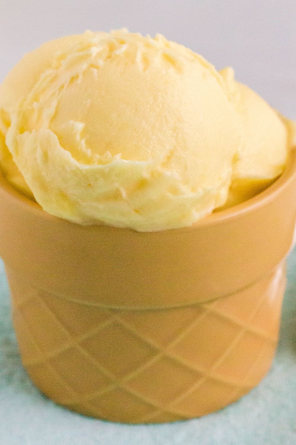 close up of creami dole ninja whip collected in a ceramic dessert cup that is shaped like an ice cream cone.