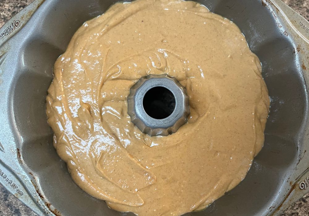 sweet potato cake batter in a greased bundt pan before baking