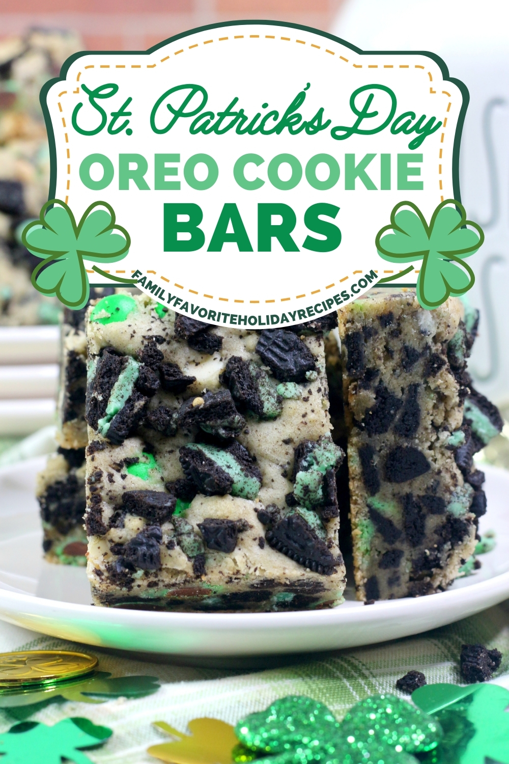 a few St. Patrick's Day Oreo cookie bars served on a white plate, with shamrock confetti surrounding the plate.