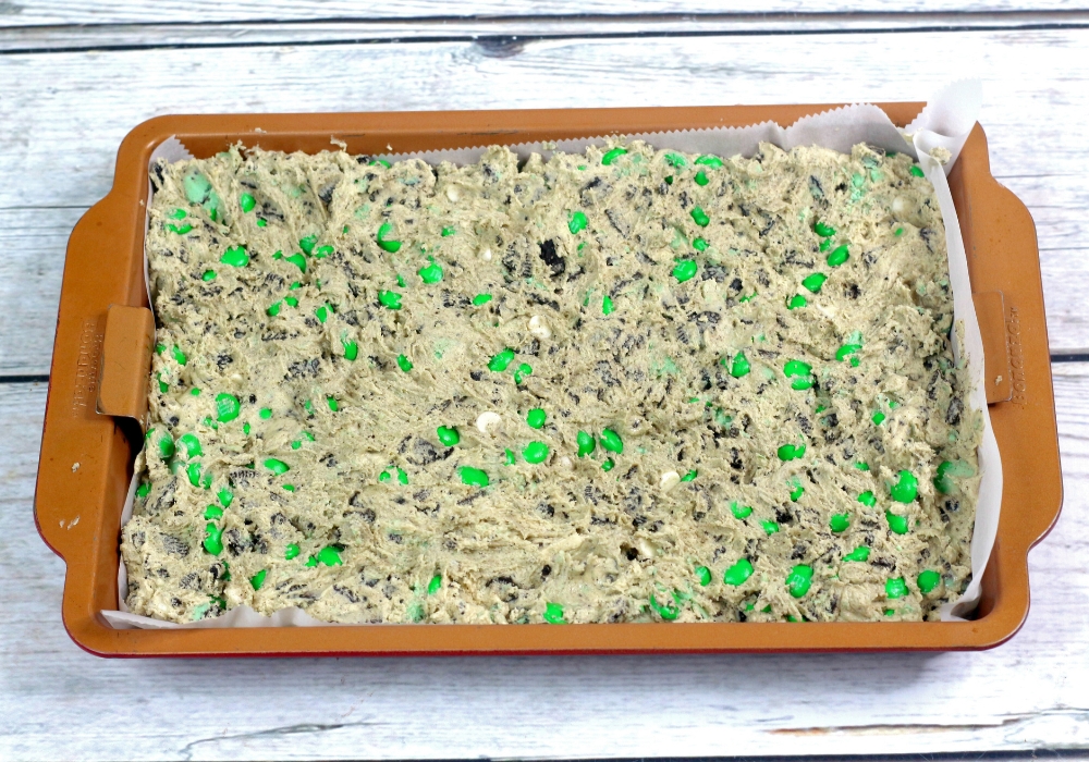 batter for mint Oreo cookie bars in a pan, ready to be baked.